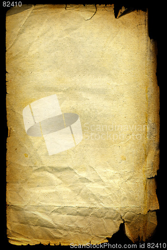 Image of Old textured paper with tattered edge. On black