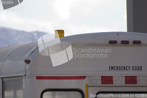 Image of Emergency Door Sign on a White Bus