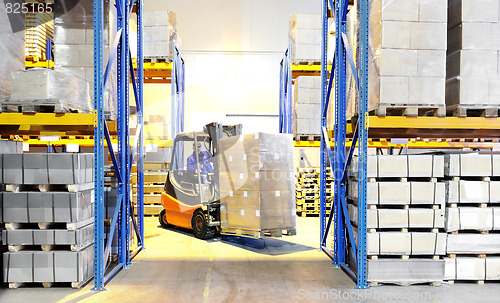 Image of forklift loader and worker at warehouse