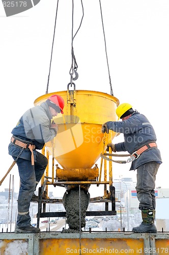 Image of construction workers at concrete work on construction site