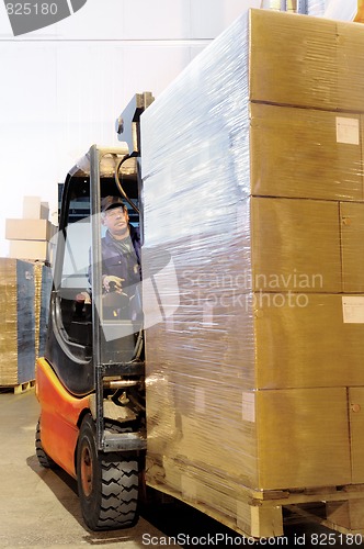 Image of forklift worker in loader at warehouse