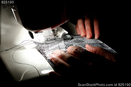 Image of hand sewing on the machine