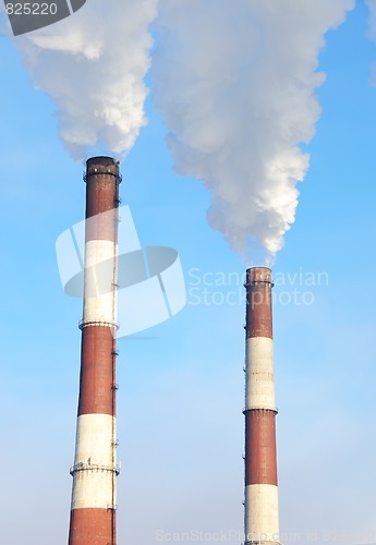 Image of two smoking chimneys of power plant