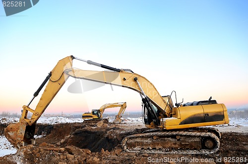 Image of two loader excavators in open cast in winter