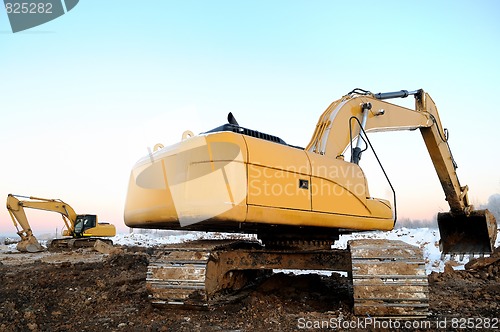 Image of two loader excavators in open cast in winter
