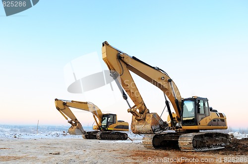 Image of two loader excavators in winter