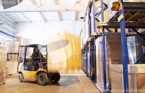 Image of at a warehouse with forklift loader