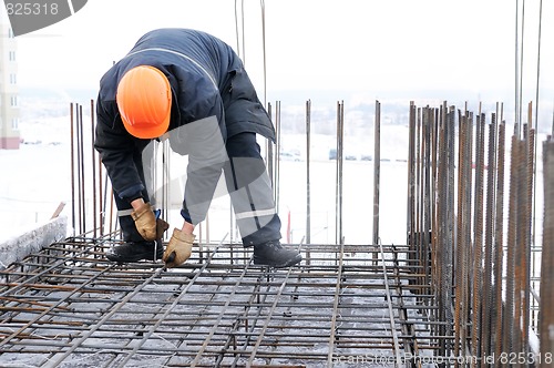 Image of worker at construction site making carcass