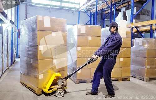 Image of worker with stacker at warehouse