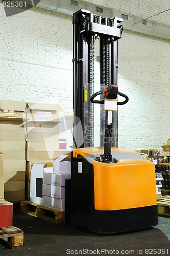 Image of warehouse forklift stacker with boxes