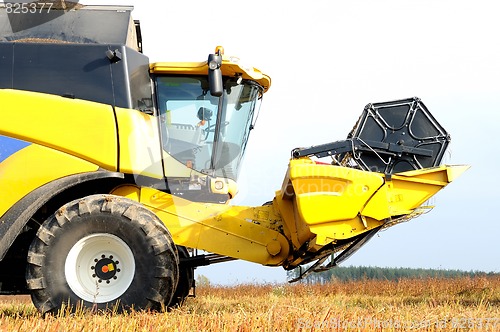 Image of combine harvester during field work on farm