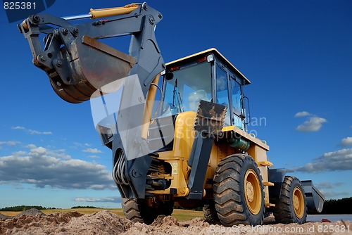 Image of rear view of  Loader excavator with rised backhoe