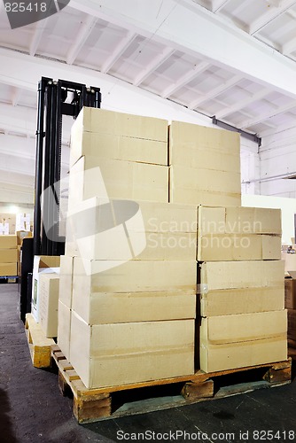 Image of warehouse forklift stacker with boxes