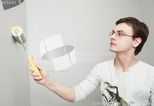 Image of Painter worker decorator with roller 