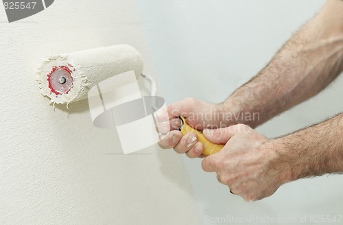 Image of Painter worker hand with roller