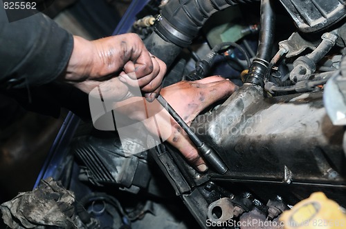 Image of mechanic repairman at car repair work