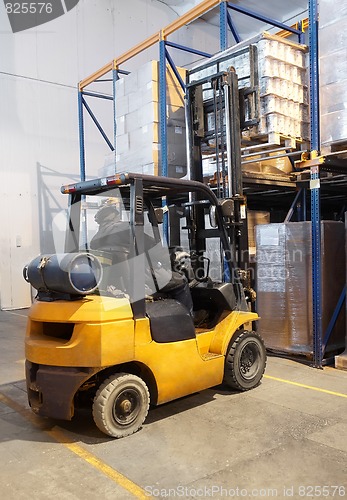 Image of forklift loader stacking in warehouse