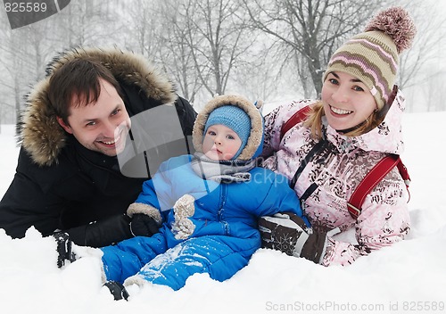 Image of smiling family with child in winter