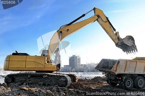 Image of loader excavator loading a rear-end tipper