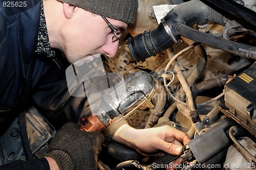 Image of mechanic repairman at car repair work