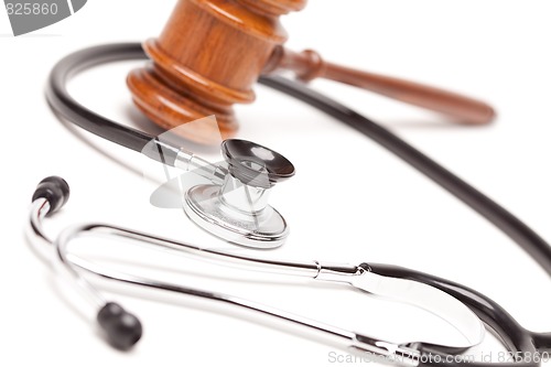 Image of Black Stethoscope and Gavel on White