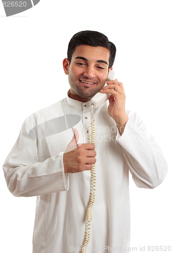 Image of Happy ethnic businessman on phone