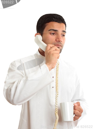 Image of Businessman on phone with coffee