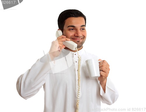 Image of Traditional ethnic business man talking on telephone