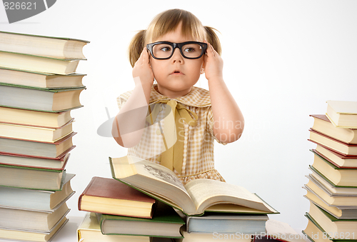 Image of Little girl with books wearing black glasses