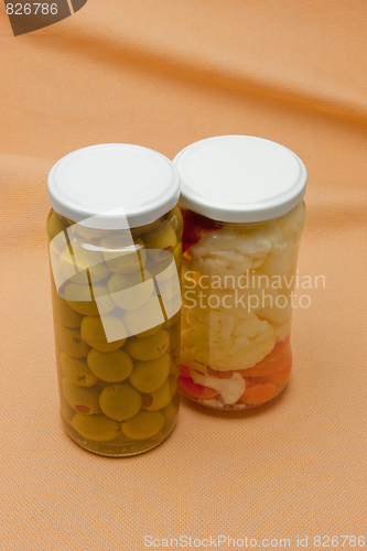 Image of Glass jars with marinated vegetables  isolated on the white back