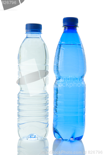 Image of Bottles  of mineral water reflected on white background