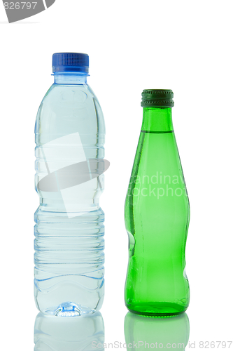 Image of Bottles  of mineral water reflected on white background