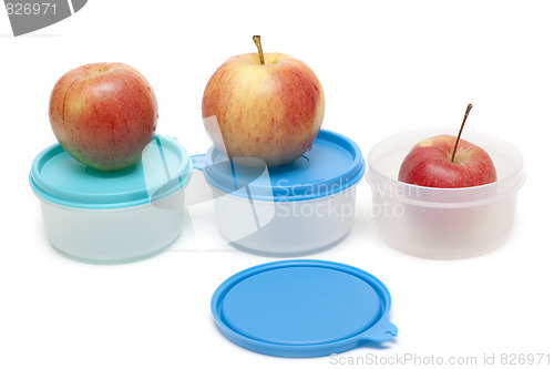 Image of Three apples and plastic containers