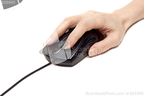 Image of Feminine hand keeps computer mouse