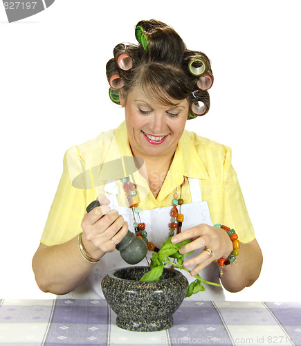 Image of Housewife Crushing Herbs