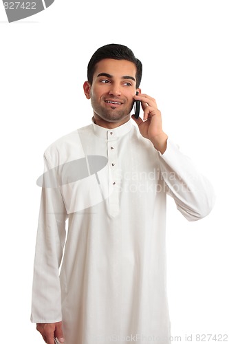 Image of Arab ethnic businessman talking cellphone