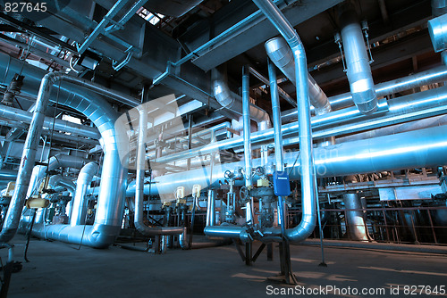 Image of Pipes, tubes, machinery and steam turbine at a power plant