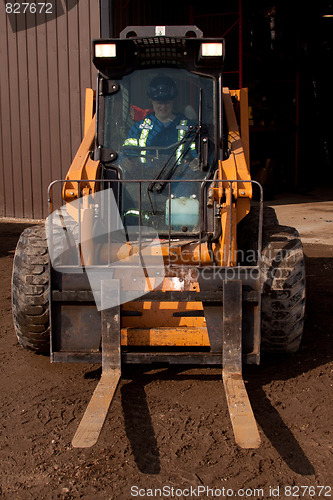 Image of Woman driving Forklift