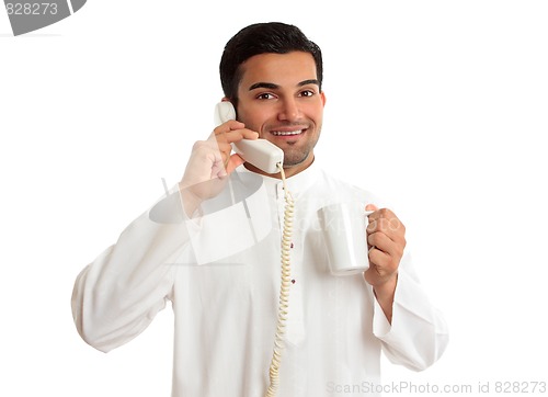 Image of Friendly smiling ethnic businessman on telephone