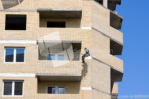 Image of Worker painting house