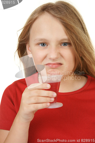 Image of young girl taking medicine