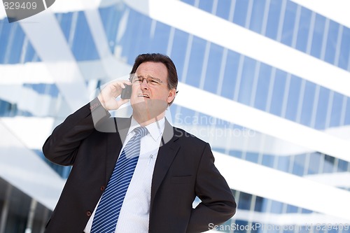 Image of Concerned Businessman Talks on His Cell Phone