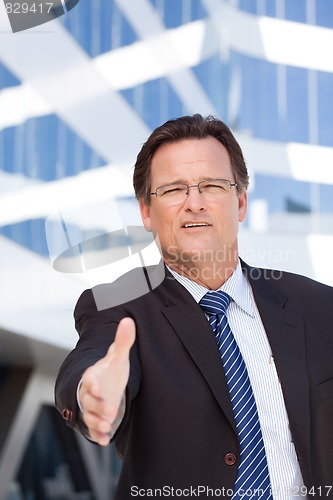 Image of Businessman Outdoors Holds Out His Hand To Shake