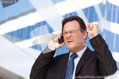 Image of Excited Businessman on Cell Phone