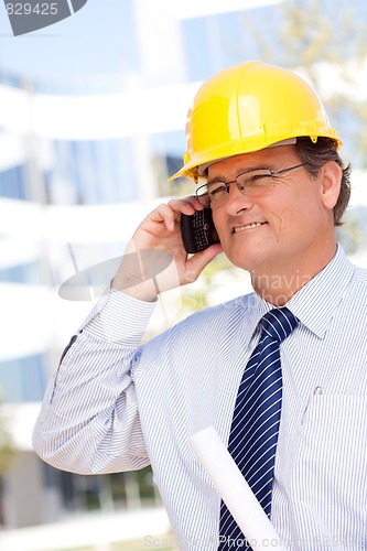 Image of Contractor in Hardhat and Necktie Talks on His Cell Phone