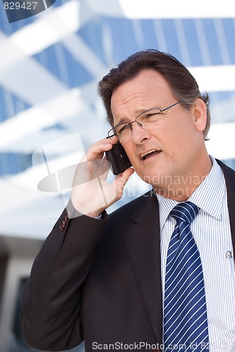 Image of Concerned Businessman Talks on His Cell Phone