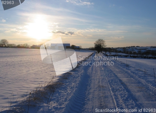 Image of Sunset over a snowy road