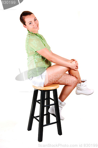 Image of Pretty girl on a bar chair.