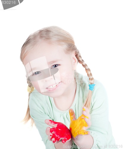 Image of Little girl playing with colors