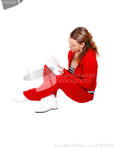 Image of Girl sitting on floor and reading. 